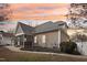 Side view of home featuring a screened porch and well maintained landscaping at 22 Hill Row Ln, Clayton, NC 27527