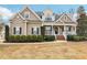 Charming two-story home with a covered porch, landscaped yard, and classic architectural details at 22 Hill Row Ln, Clayton, NC 27527