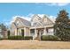 Beautiful exterior view featuring manicured lawn, inviting front porch with a swing, and attractive curb appeal at 22 Hill Row Ln, Clayton, NC 27527