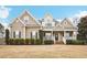 Charming home showcasing manicured landscaping, inviting porch, and classic architectural details at 22 Hill Row Ln, Clayton, NC 27527