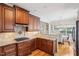 This kitchen features wood floors, granite counters, stainless cooktop, and cherry cabinets at 22 Hill Row Ln, Clayton, NC 27527