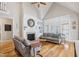 Cozy living room featuring hardwood floors, fireplace, and ample natural light at 22 Hill Row Ln, Clayton, NC 27527