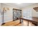Spacious office with hardwood floors, shelving and a large wooden desk perfect for working from home at 22 Hill Row Ln, Clayton, NC 27527