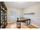 Bright office featuring hardwood floors, built-in shelves, large window, and a spacious wooden desk at 22 Hill Row Ln, Clayton, NC 27527