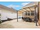 Home's rear exterior features a covered patio area with a table and chairs at 22 Hill Row Ln, Clayton, NC 27527