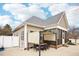 Home's rear exterior features a covered patio area with a table and chairs at 22 Hill Row Ln, Clayton, NC 27527