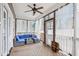 Relaxing screened porch with comfortable seating, ceiling fan, curtains, and wood floors at 22 Hill Row Ln, Clayton, NC 27527