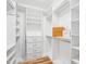 Bright and well organized walk-in closet with custom shelving and drawers for ample storage at 22 Hill Row Ln, Clayton, NC 27527