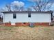 Exterior view of a home with a backyard, showcasing the architecture and outdoor space at 2412 Little John Rd, Raleigh, NC 27610