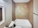 Well-maintained bathroom featuring tiled walls, a bathtub, and modern fixtures at 2412 Little John Rd, Raleigh, NC 27610