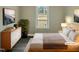 Cozy bedroom with hardwood floors, comfortable bed, and a picturesque view from the window at 2412 Little John Rd, Raleigh, NC 27610