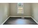 Clean bedroom featuring hardwood floors and a bright window at 2412 Little John Rd, Raleigh, NC 27610
