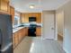Functional kitchen equipped with wooden cabinets, black appliances, and durable countertops at 2412 Little John Rd, Raleigh, NC 27610