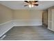 Spacious living room featuring light walls, modern gray floors, and a doorway to another room at 2412 Little John Rd, Raleigh, NC 27610