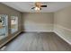 Spacious living room with hardwood floors and natural light from multiple windows at 2412 Little John Rd, Raleigh, NC 27610