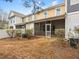 Townhome backyard featuring a screened in porch, patio, and mature landscaping at 2459 Memory Ridge Dr, Raleigh, NC 27606