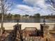 A scenic beach access point with stairs and stone pillars leading to a sandy area with lake views and a fountain at 2459 Memory Ridge Dr, Raleigh, NC 27606