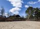 Community beach with volleyball net and swimming area, and an outdoor picnic area, offering a relaxed lakeside lifestyle at 2459 Memory Ridge Dr, Raleigh, NC 27606