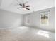 Spacious bedroom with tray ceiling, carpet flooring, and large windows offering natural light at 2459 Memory Ridge Dr, Raleigh, NC 27606