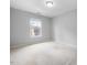 This carpeted bedroom has a large window offering plenty of natural light at 2459 Memory Ridge Dr, Raleigh, NC 27606