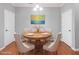 Staged dining room with modern décor featuring wood table with seating for four at 2459 Memory Ridge Dr, Raleigh, NC 27606