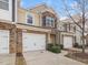 Attractive townhome exterior with brick accents, well-kept lawn, and convenient driveway at 2459 Memory Ridge Dr, Raleigh, NC 27606