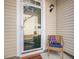 Inviting front porch with neutral siding, a comfortable chair, and a secure Ring doorbell at 2459 Memory Ridge Dr, Raleigh, NC 27606