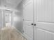 Hallway with neutral carpet with access to several bedrooms and closets at 2459 Memory Ridge Dr, Raleigh, NC 27606