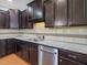 Kitchen featuring dark cabinets, granite countertops, stainless steel appliances, and tile backsplash at 2459 Memory Ridge Dr, Raleigh, NC 27606