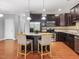 Kitchen featuring stainless steel appliances, dark cabinets, and a kitchen island with granite countertops at 2459 Memory Ridge Dr, Raleigh, NC 27606