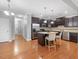 Open kitchen with stainless steel appliances, island with bar stools and hardwood floors at 2459 Memory Ridge Dr, Raleigh, NC 27606