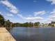 Scenic lake view featuring a fountain, waterfront homes, blue skies and verdant trees along the banks at 2459 Memory Ridge Dr, Raleigh, NC 27606