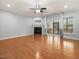 Open living room with hardwood floors, fireplace and sliding glass doors at 2459 Memory Ridge Dr, Raleigh, NC 27606