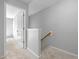 Bright staircase with gray walls, carpeted steps, and wooden banister leads to the upper floor at 2459 Memory Ridge Dr, Raleigh, NC 27606