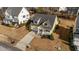 This aerial view showcases a beautiful yellow home with a well-maintained yard, landscaping, and a welcoming front porch at 2500 Plowridge Rd, Fuquay Varina, NC 27526