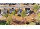Aerial view of the property highlighting a spacious backyard with mature trees, a patio, and surrounding neighborhood at 2500 Plowridge Rd, Fuquay Varina, NC 27526