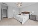 Relaxing primary bedroom with a ceiling fan, en-suite bathroom, and neutral gray color palette at 2500 Plowridge Rd, Fuquay Varina, NC 27526