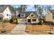 Charming yellow two-story home with a well-manicured lawn and attached two-car garage at 2500 Plowridge Rd, Fuquay Varina, NC 27526