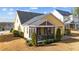 View of the home's exterior showcasing a screened porch, patio, and beautifully landscaped yard at 2500 Plowridge Rd, Fuquay Varina, NC 27526