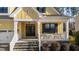 Inviting front porch with stone steps, a seating area, and classic columns at 2500 Plowridge Rd, Fuquay Varina, NC 27526