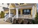 Inviting front porch with white railings and stone steps leads to a cheerful yellow home at 2500 Plowridge Rd, Fuquay Varina, NC 27526