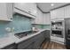 Bright kitchen with a gas cooktop, subway tile backsplash, and stainless steel microwave and oven at 2500 Plowridge Rd, Fuquay Varina, NC 27526