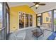 Relax on this screened porch, offering a view of the house's yellow exterior and a comfortable seating area at 2500 Plowridge Rd, Fuquay Varina, NC 27526