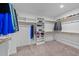 Spacious walk-in closet with custom shelving, hanging rods, and carpeted floors at 2500 Plowridge Rd, Fuquay Varina, NC 27526