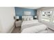 Bedroom with blue accent wall, white bedding, side tables, and a large window at 287 Beacon Dr, Pittsboro, NC 27312