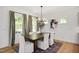 Bright dining room boasts a chandelier, large windows, and hardwood floors at 287 Beacon Dr, Pittsboro, NC 27312