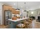 Open kitchen features a center island with seating and stainless steel appliances at 287 Beacon Dr, Pittsboro, NC 27312