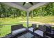 Relaxing screened porch with comfortable seating overlooking a lush, green yard at 287 Beacon Dr, Pittsboro, NC 27312