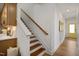Bright stairway features open treads, white risers, wood handrail, and access to the main level and upper level at 287 Beacon Dr, Pittsboro, NC 27312
