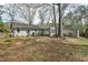 Large backyard featuring mature trees, great for outdoor activities and relaxation at 303 Granville Rd, Chapel Hill, NC 27514